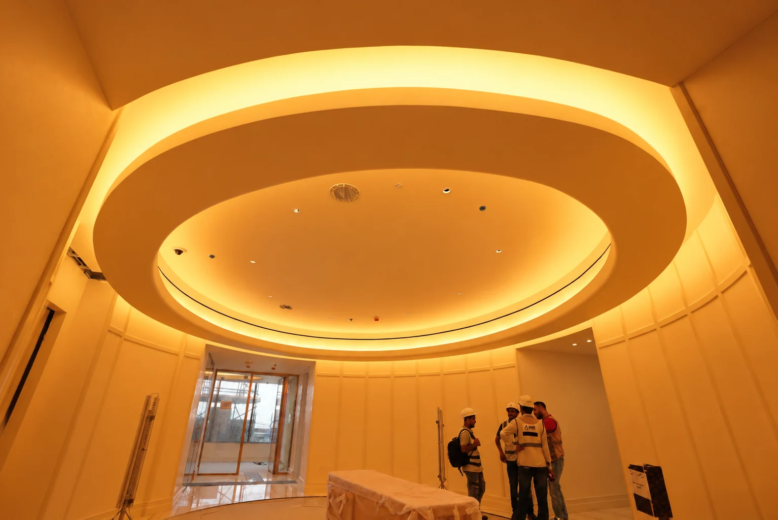 Circular sculptural ceiling with warm concealed lighting